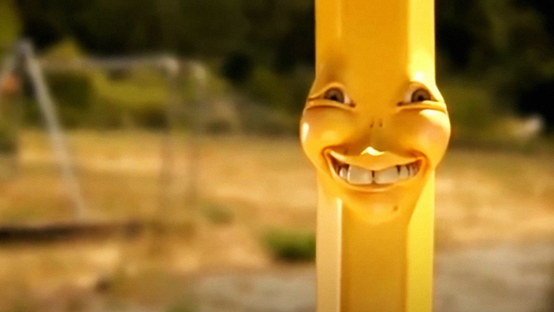 A yellow pencil with a person's face is looking at the camera and smiling against the backdrop of a street
