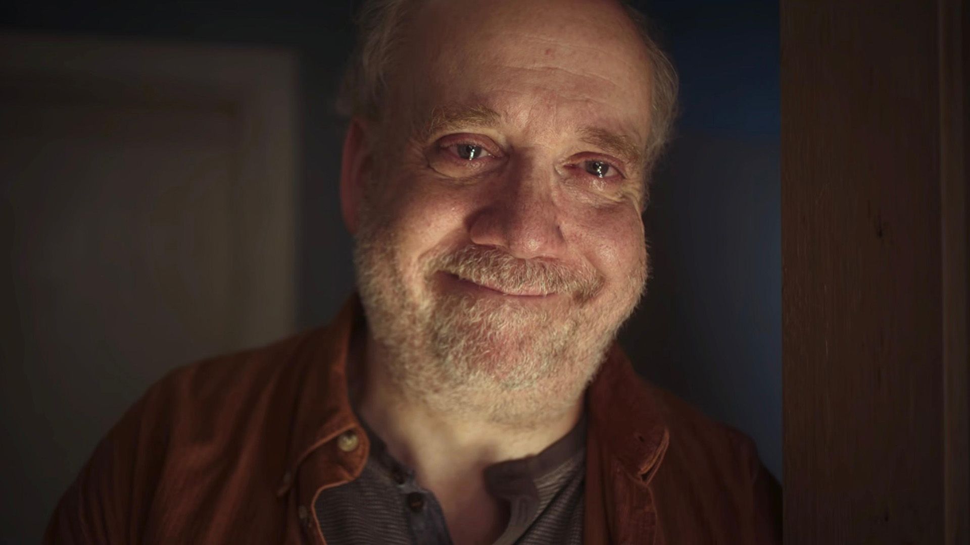 Paul Giamatti smiles with eyes full of tears