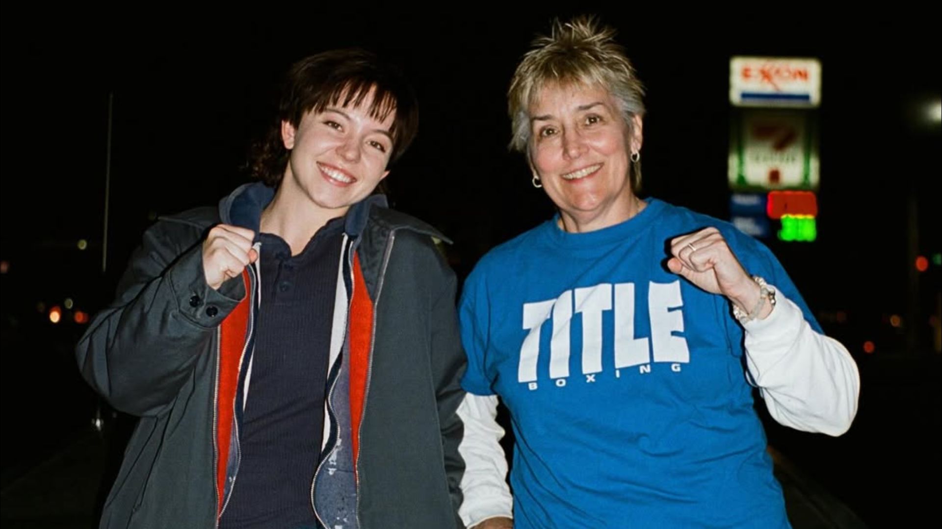 Actress Sydney Sweeney and boxer Christy Martin raising their fists and smiling