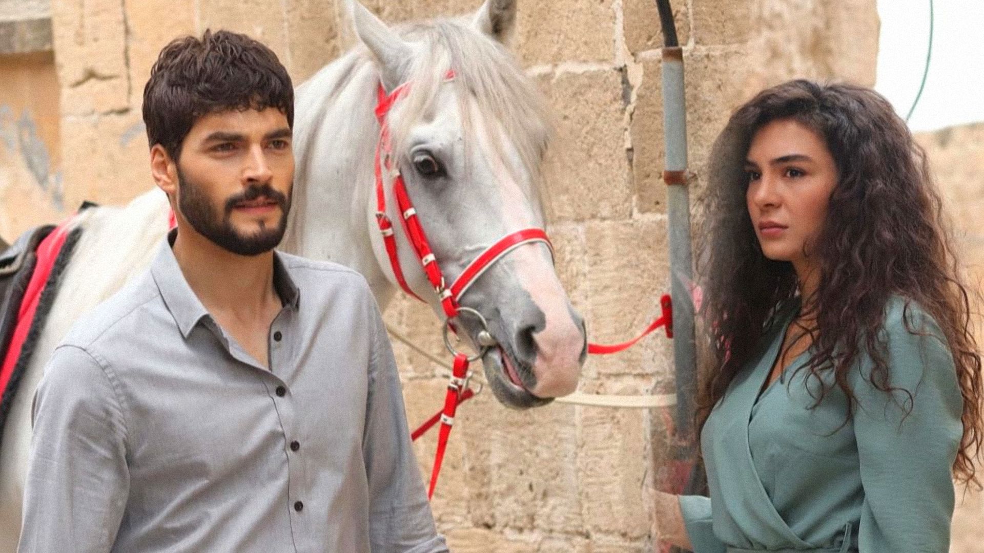 A man in a shirt and a girl in a dress are standing next to a white horse