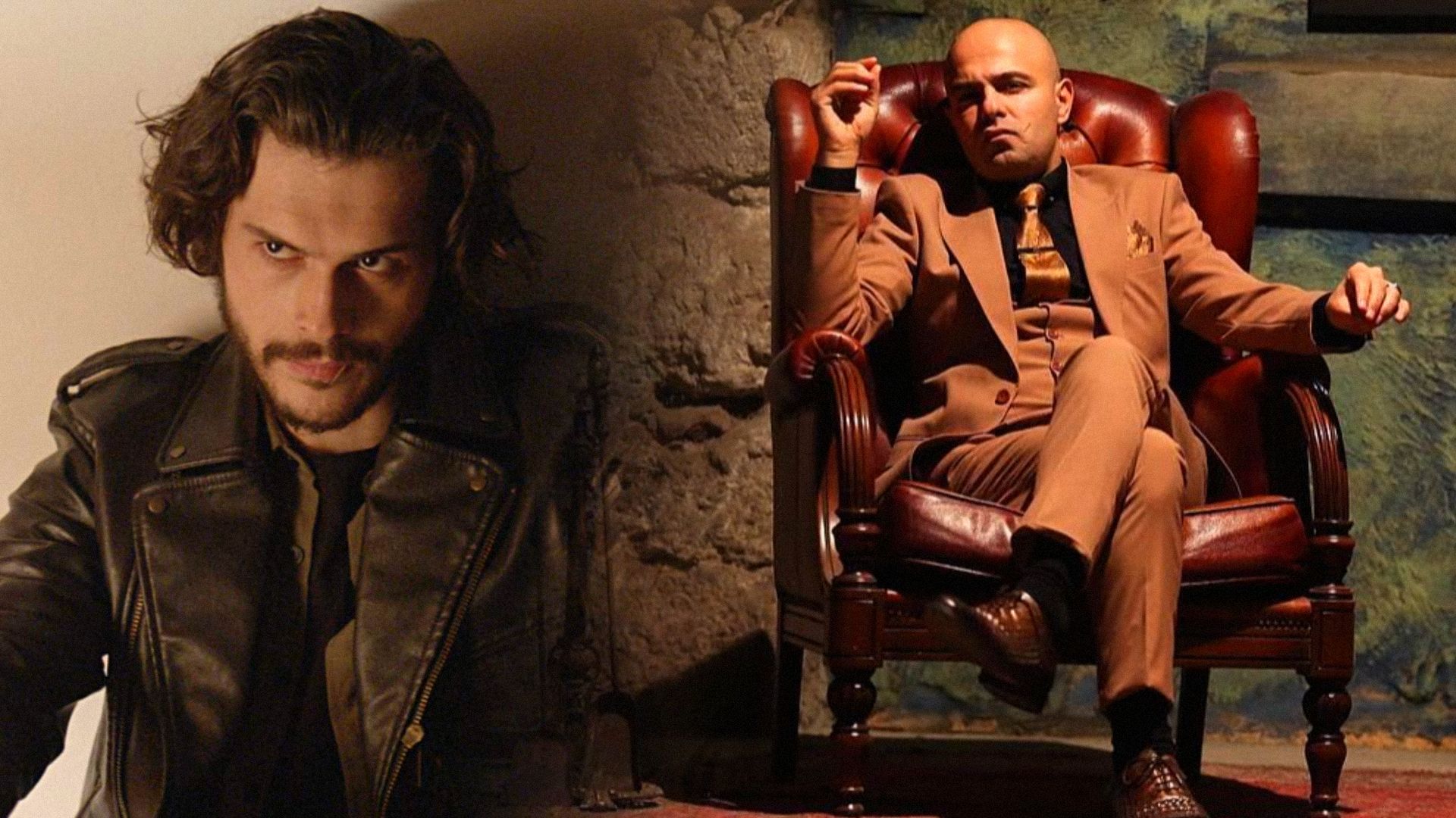 A man with long hair and wearing a black jacket and a man in a suit sitting on a chair