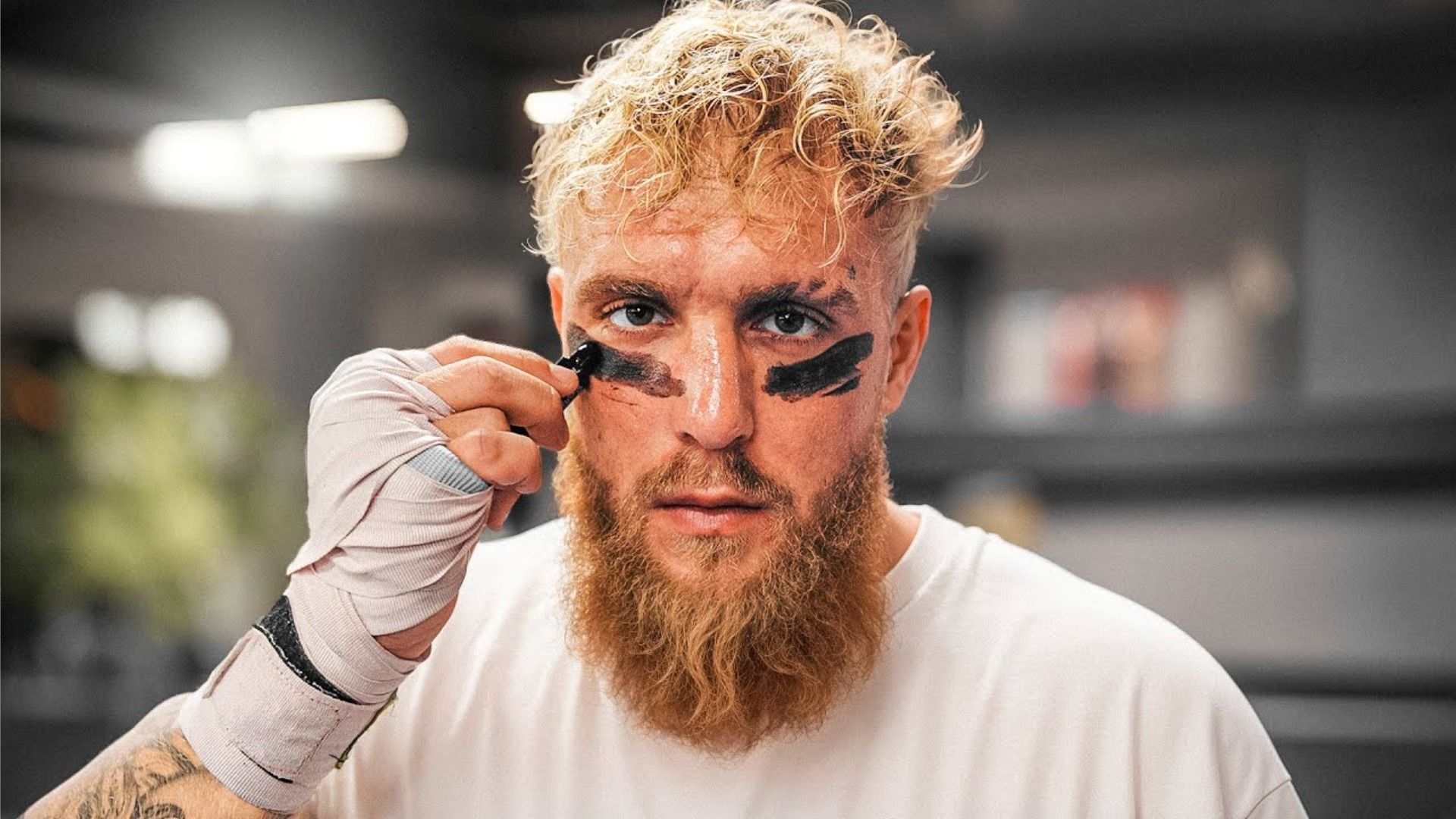 Blogger Jake Paul in a white t-shirt and in a football player outfit