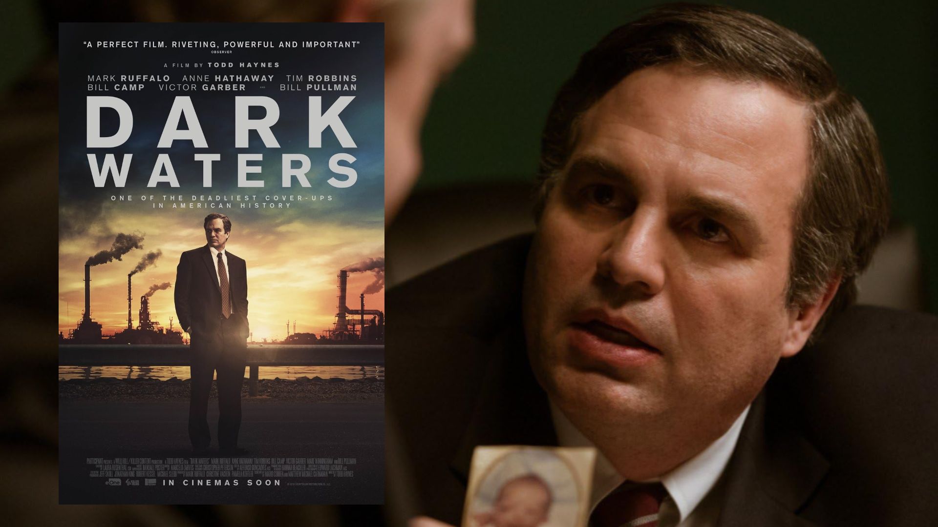Actor Mark Ruffalo in a black jacket shows a photograph and looks to the side