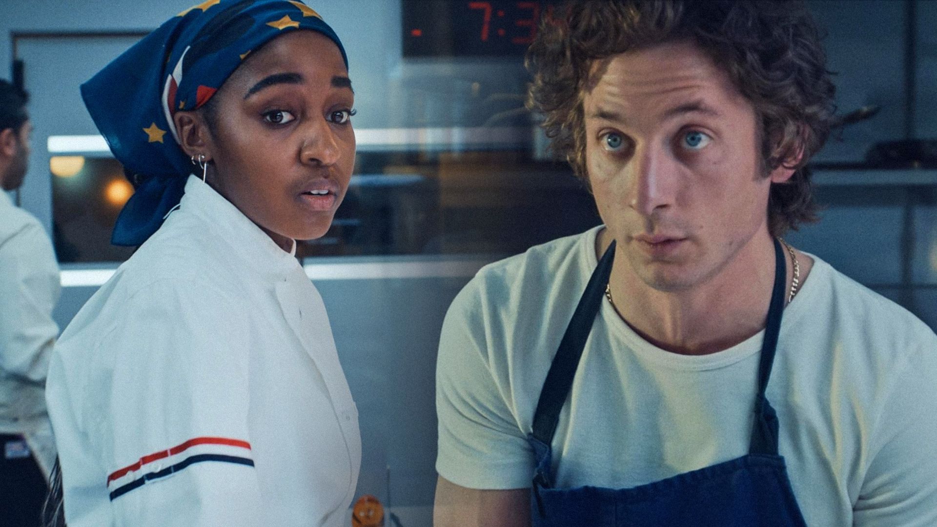 A girl with a headscarf in chef's clothing and actor Jeremy Allen White in a blue apron