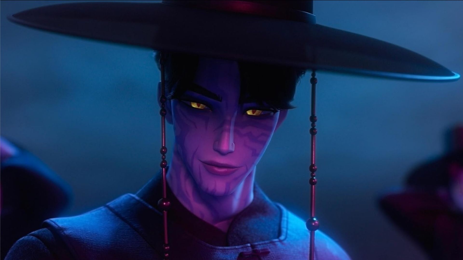 A guy in a wide-brimmed hat smiles in pink light