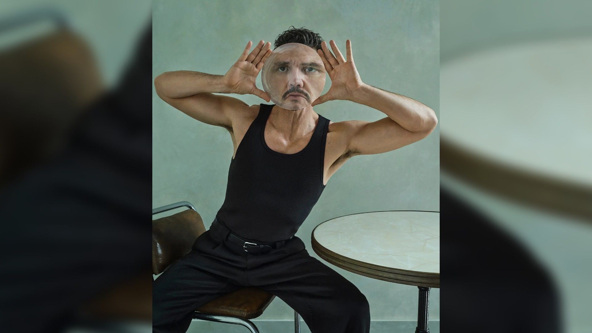 Pedro Pascal holding a magnifying glass and looking through it