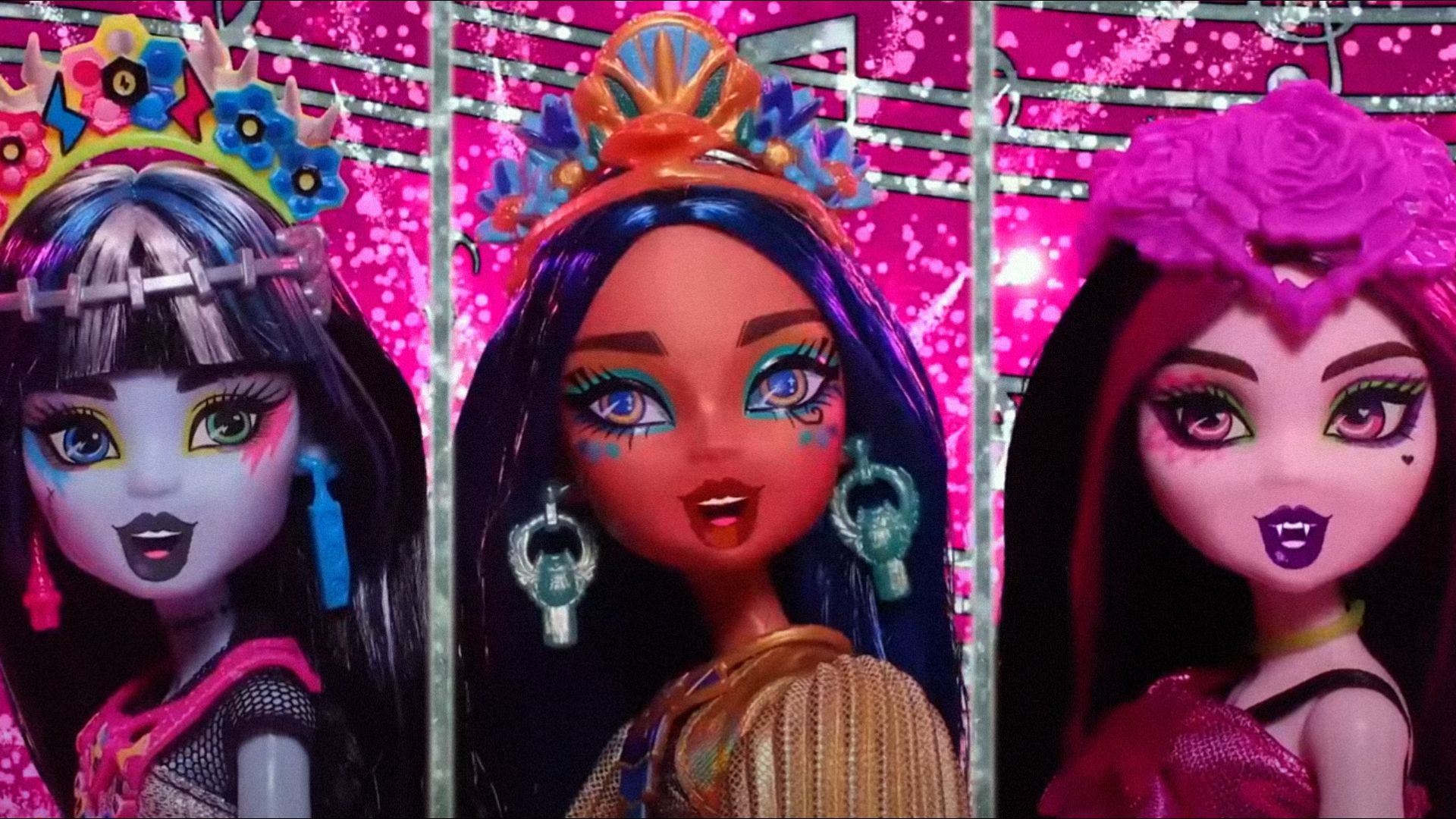 Three dolls with bright makeup and vampire fangs