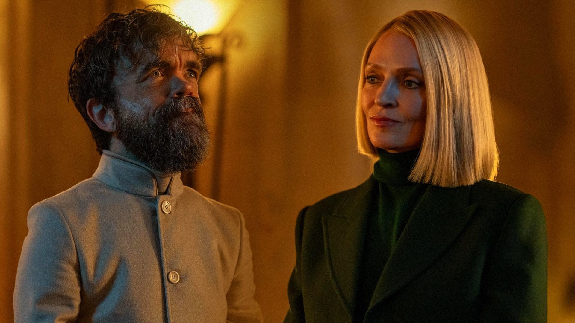 Actor Peter Dinklage with a short haircut and in white clothing, actress Uma Thurman in a green blazer