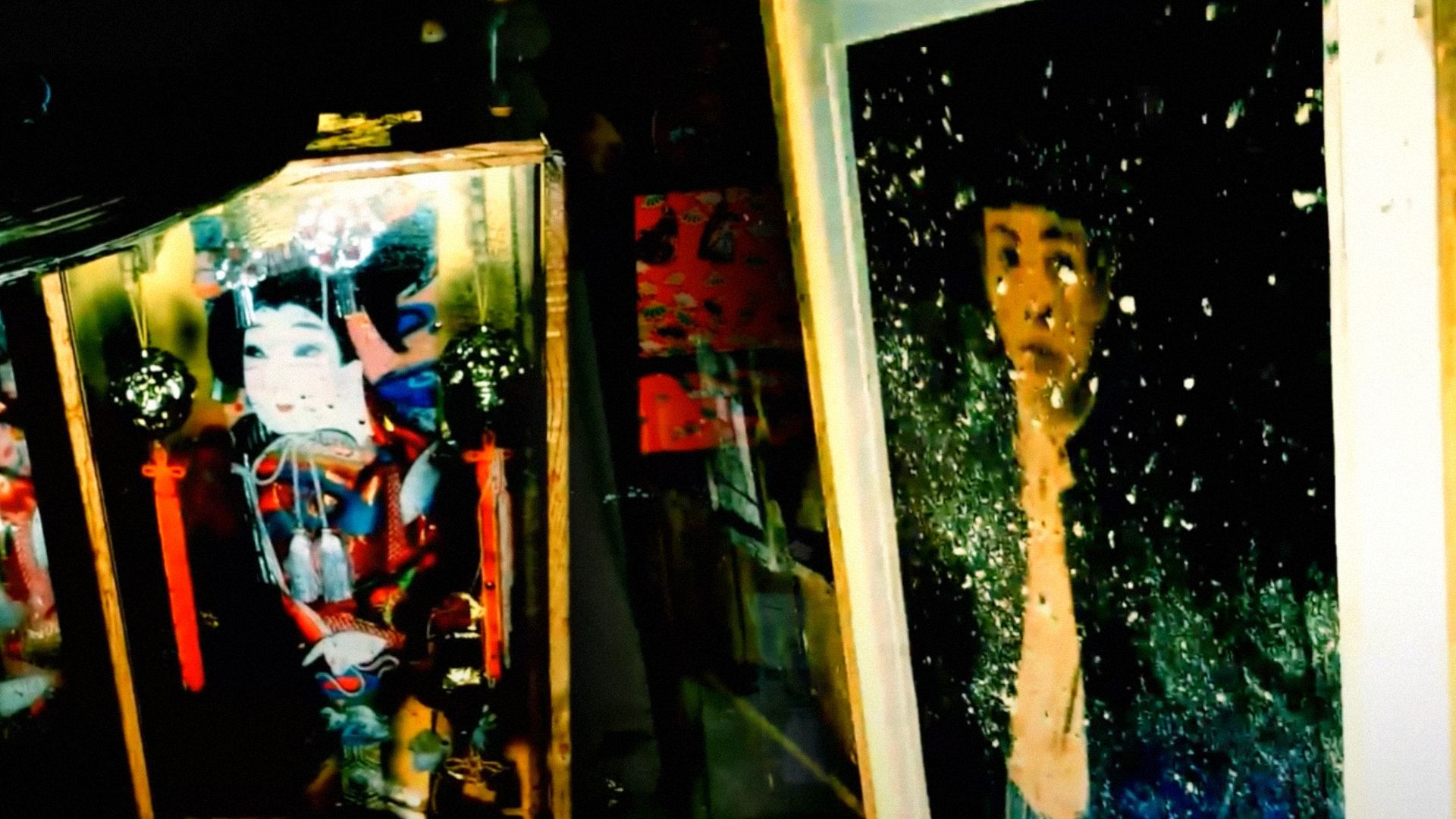 A photograph of a woman with black hair and a painting depicting an Asian woman