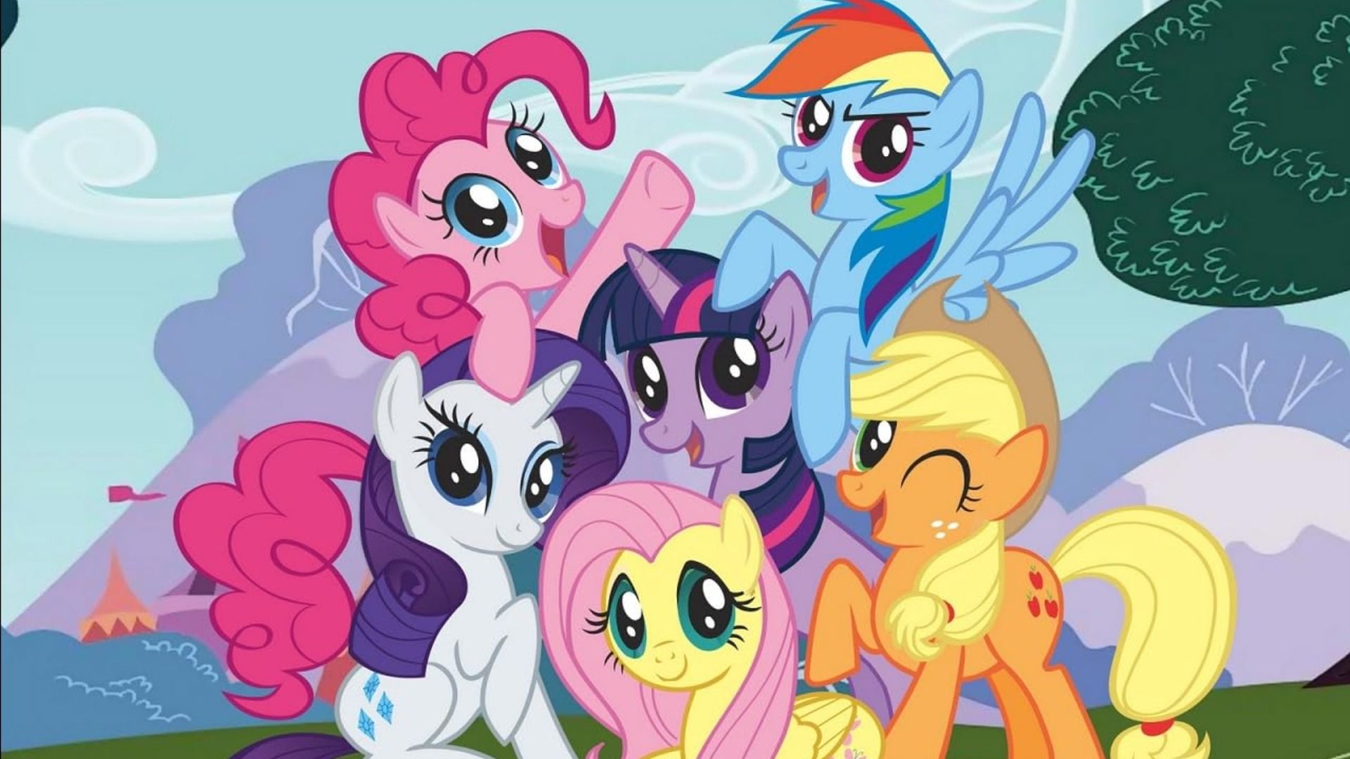 Ponies with multicolored manes standing near a tree and smiling