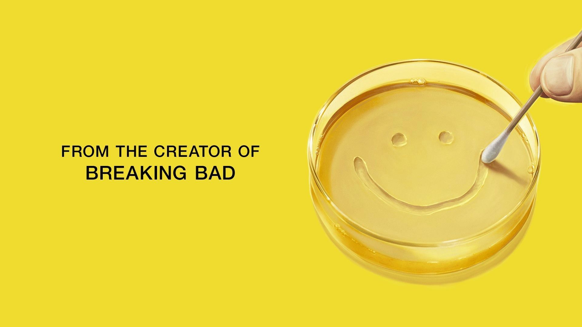A human hand draws a smiley face with a cotton swab in a petri dish against a yellow background