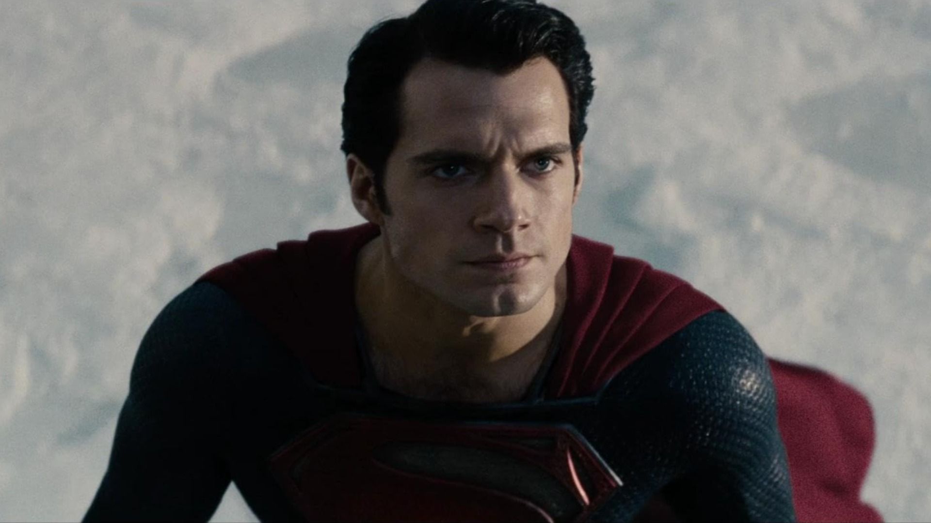 Actor Henry Cavill in a blue and red superhero costume with the letter S on his chest