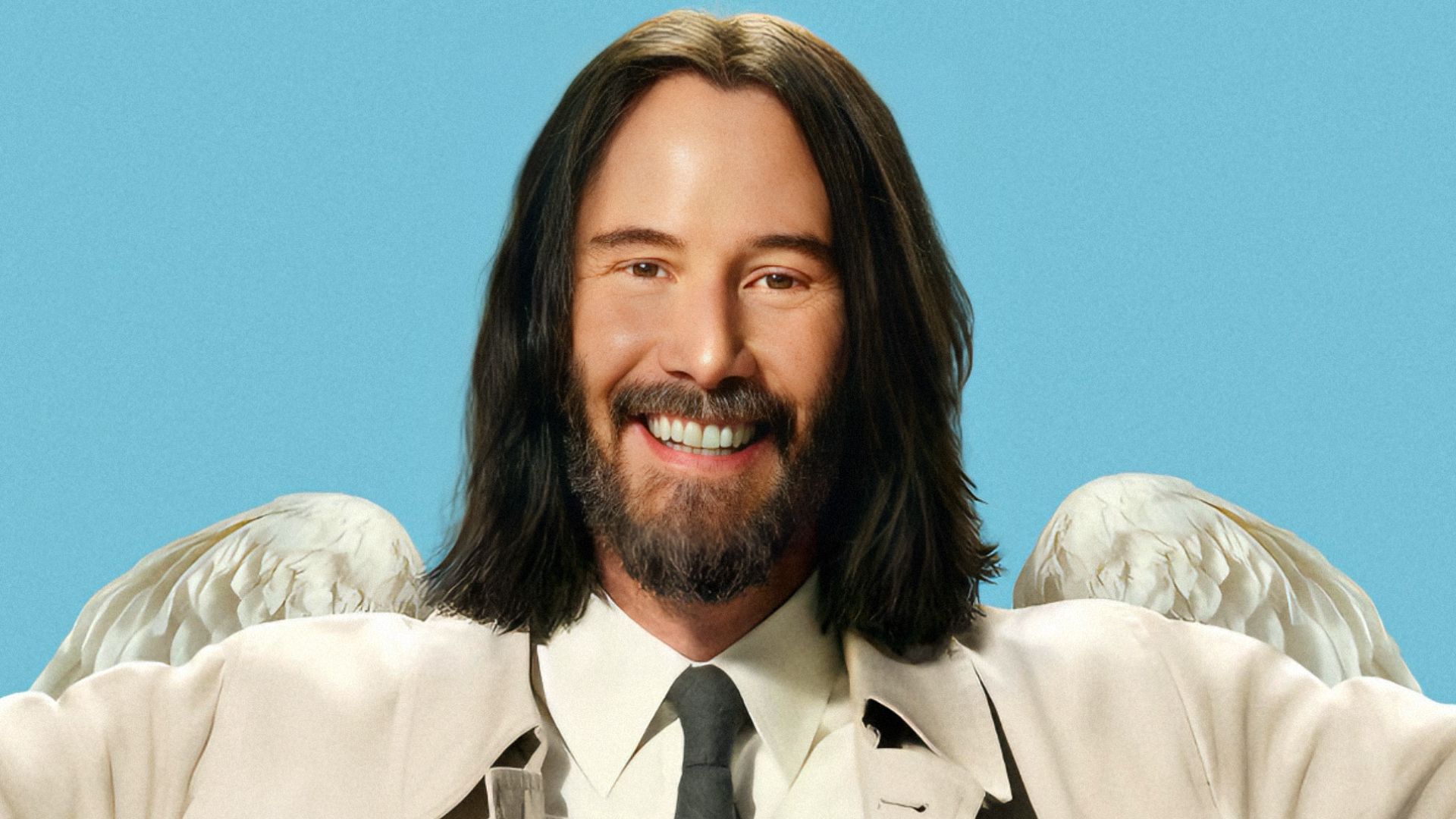 Actor Keanu Reeves in a beige coat with white wings on his back smiles at the camera against a blue background