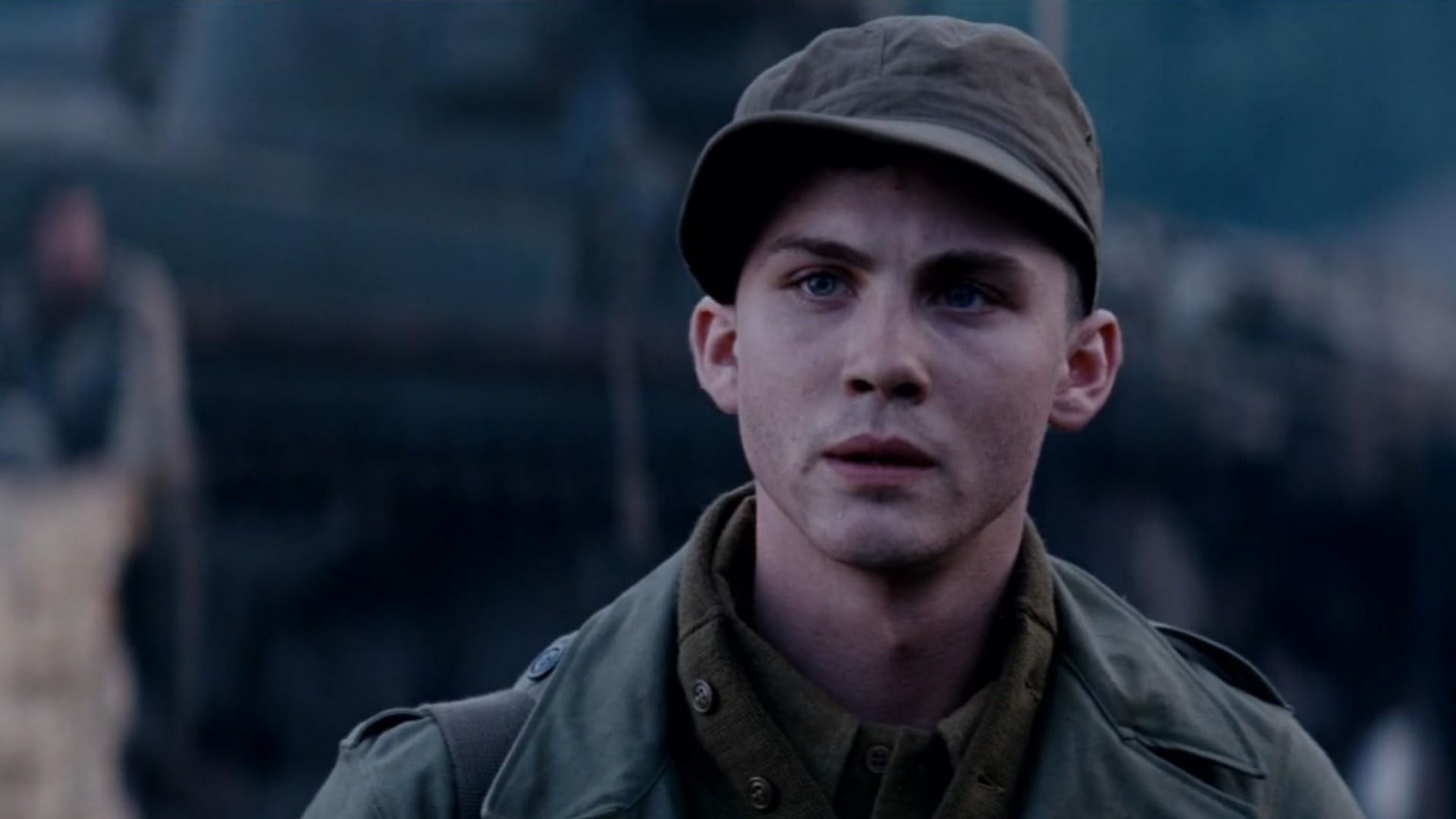 Actor Logan Lerman in military uniform with a cap on his head