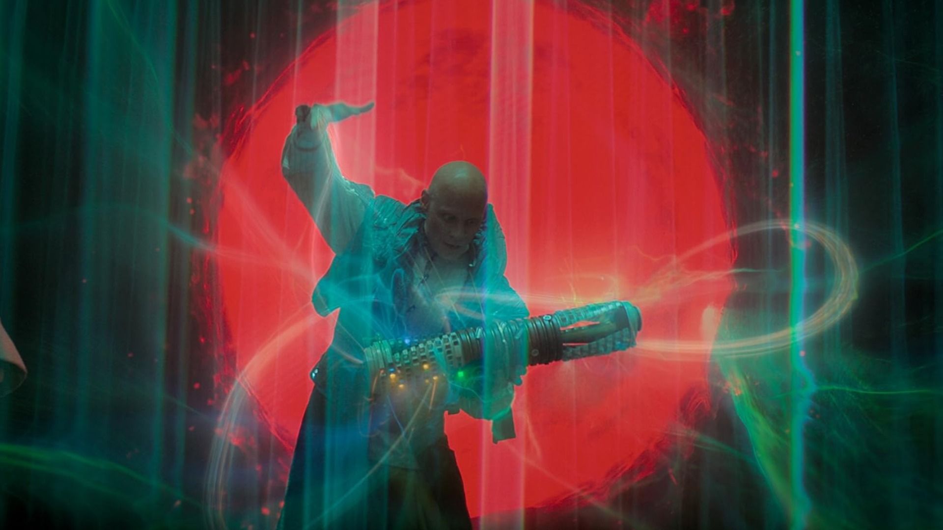 A bald man in white clothing holds a futuristic weapon against a red circle backdrop