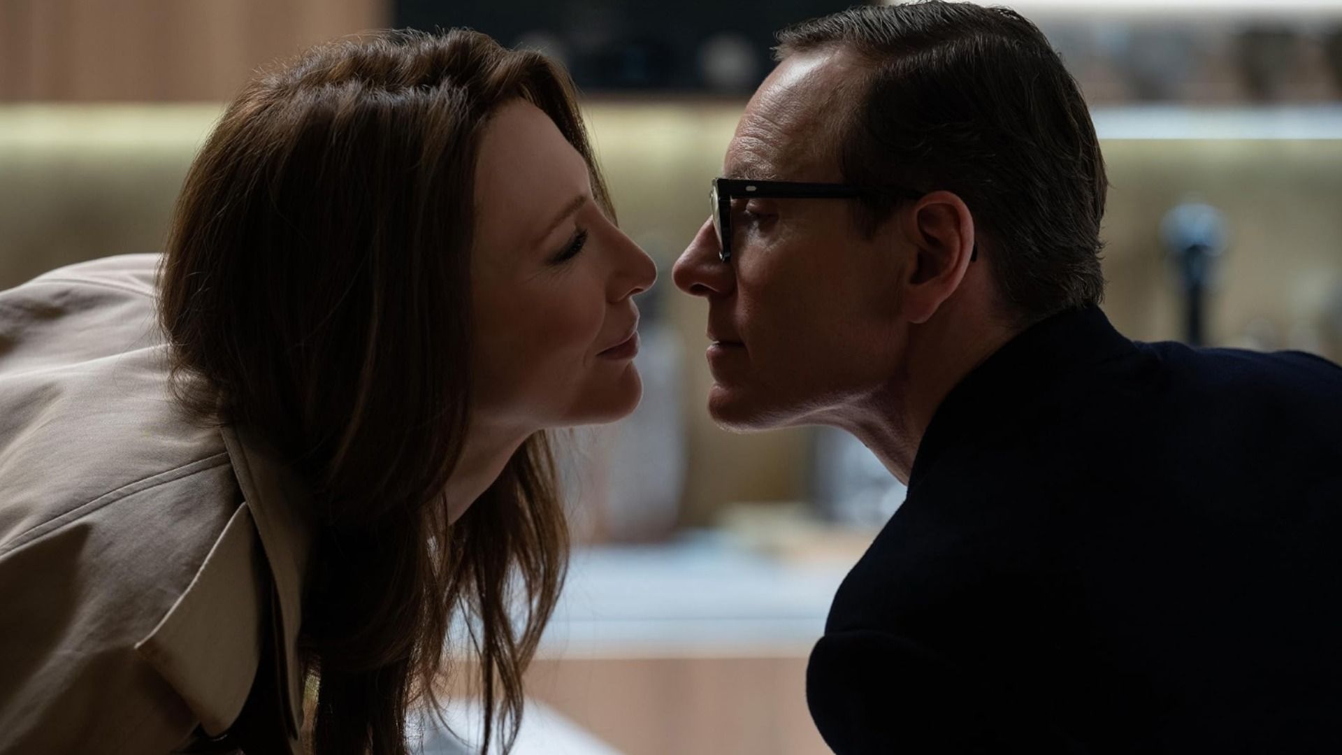 Actors Cate Blanchett and Michael Fassbender kiss against a blurred background