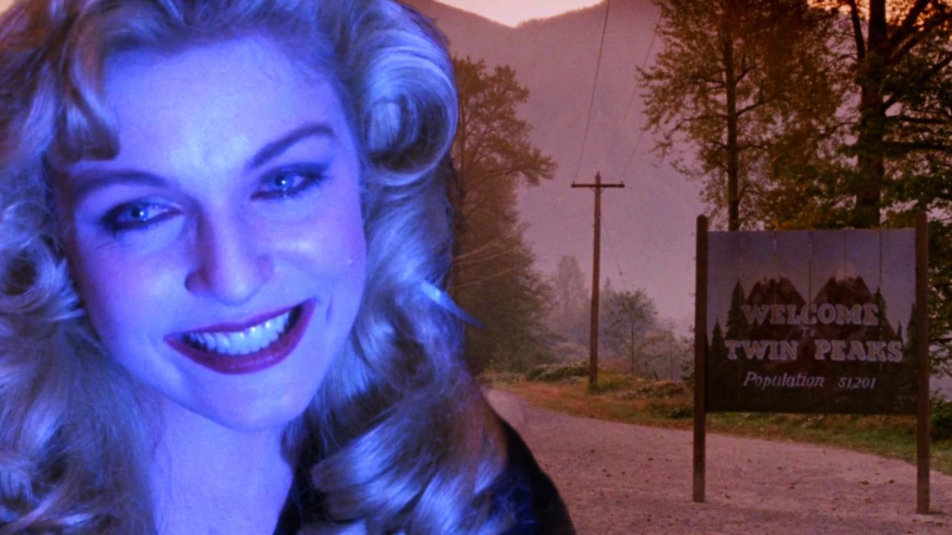Actress Sheryl Lee smiles in blue light next to a street with a wooden sign reading Twin Peaks