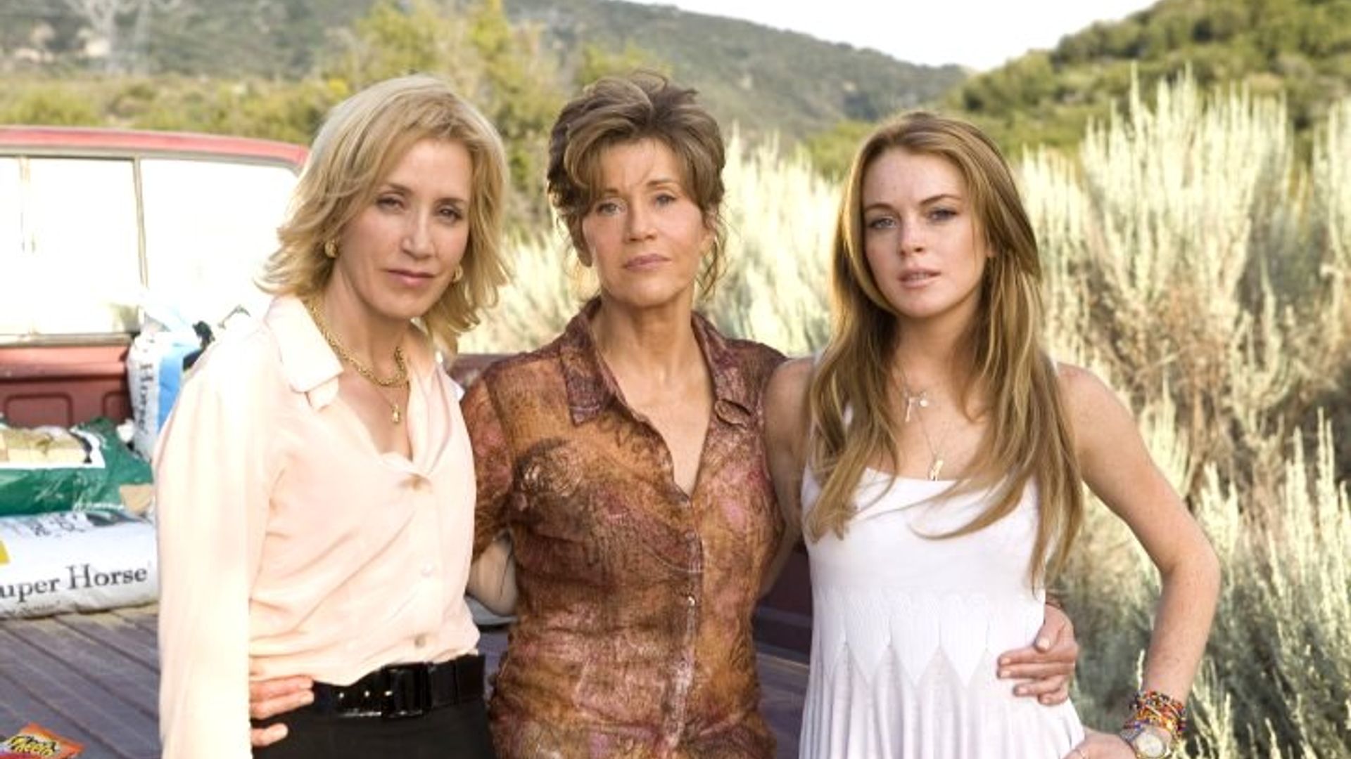 Felicity Huffman, Jane Fonda and Lindsay Lohan pose for the camera on the street