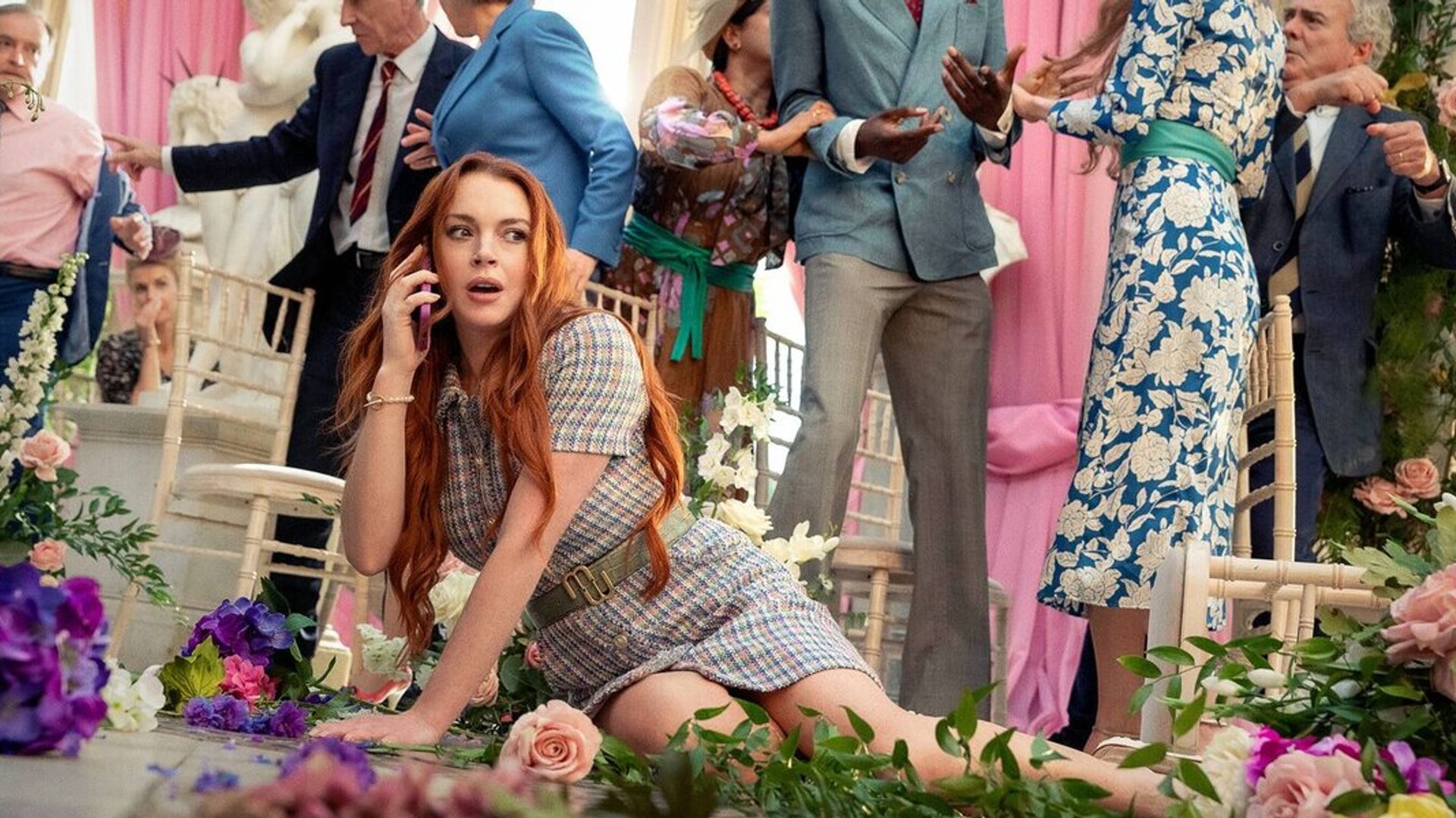 Lindsay Lohan fell on the floor among flowers while talking on the phone with wedding ceremony chaos in the background