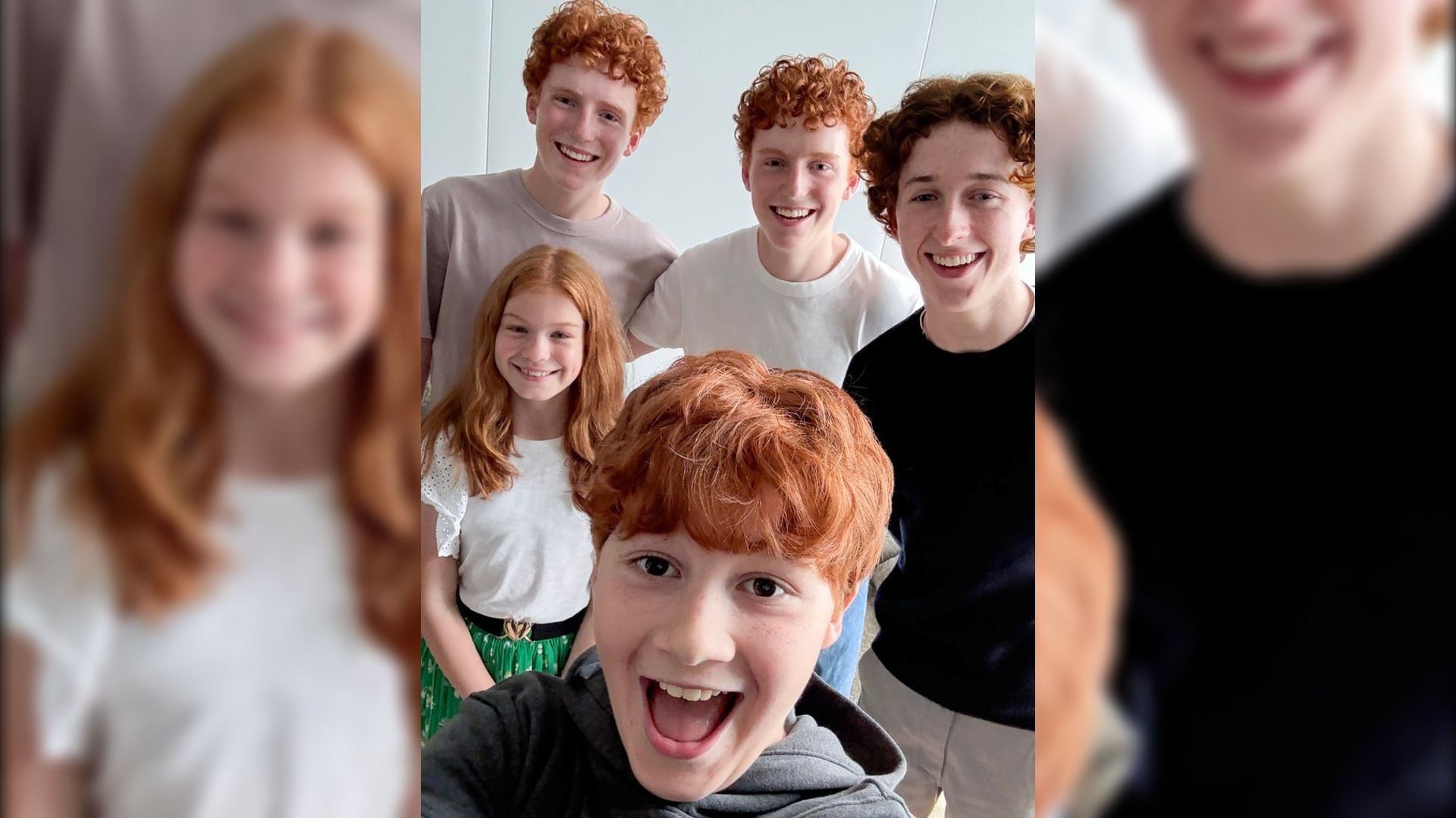 Four red-haired guys smiling next to a red-haired girl