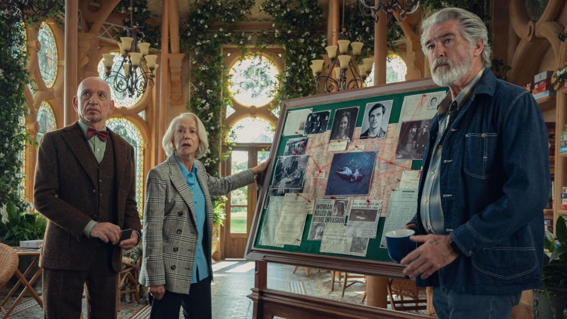 Actors Ben Kingsley in a brown suit, Helen Mirren in a gray blazer and Pierce Brosnan in a denim jacket