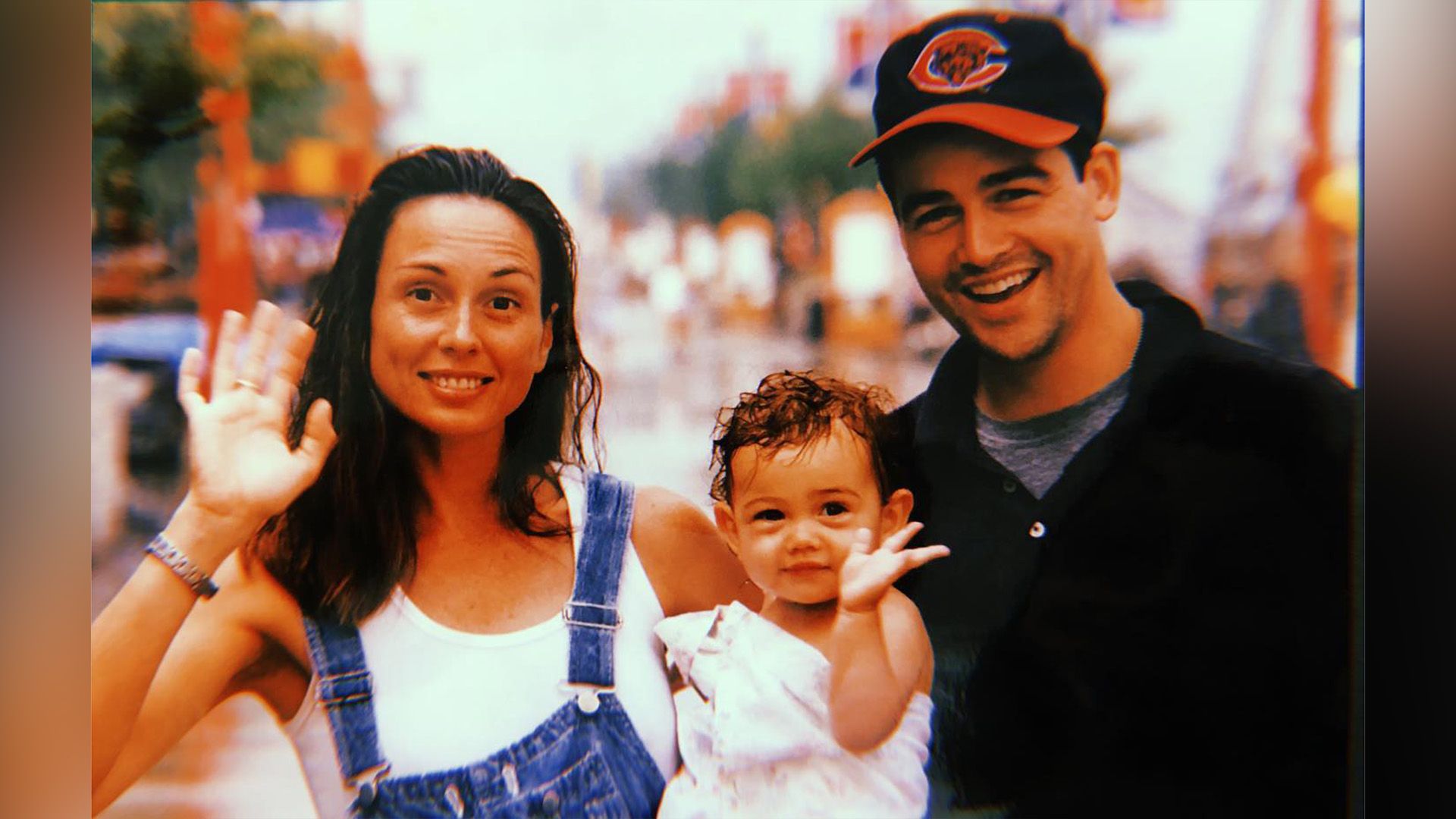 Sydney Chandler as a child in her mother Kathryn MacQuarrie's arms, with Kyle Chandler standing nearby