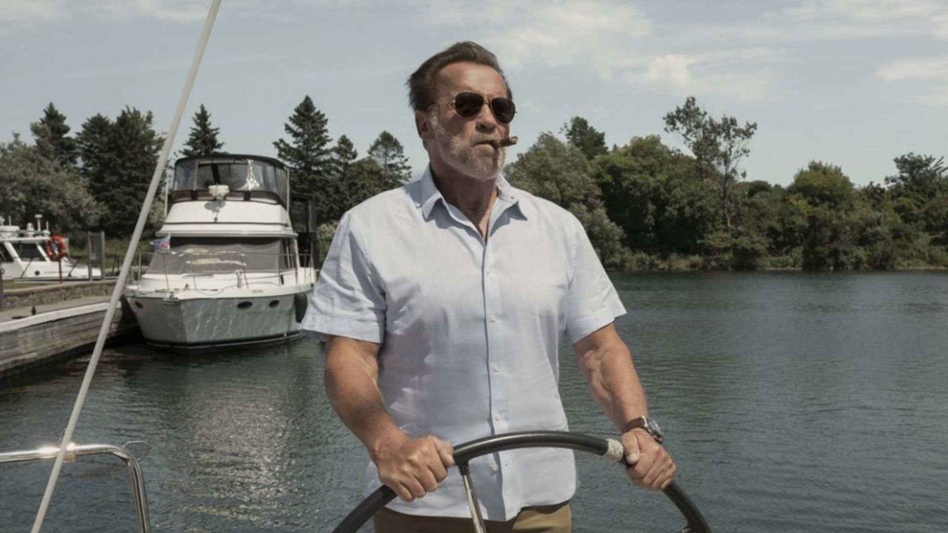 Arnold Schwarzenegger piloting a boat