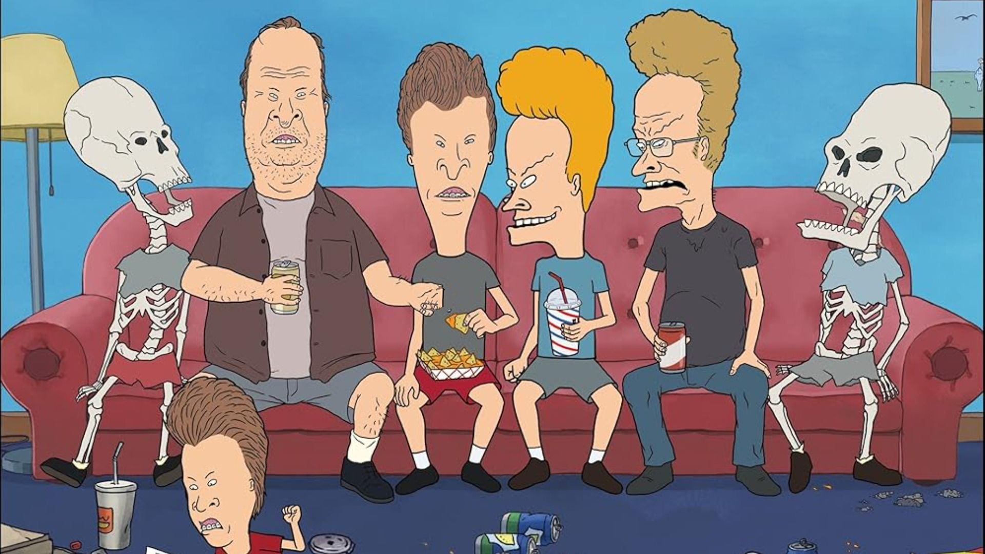 A group of men in colorful t-shirts sitting on a couch