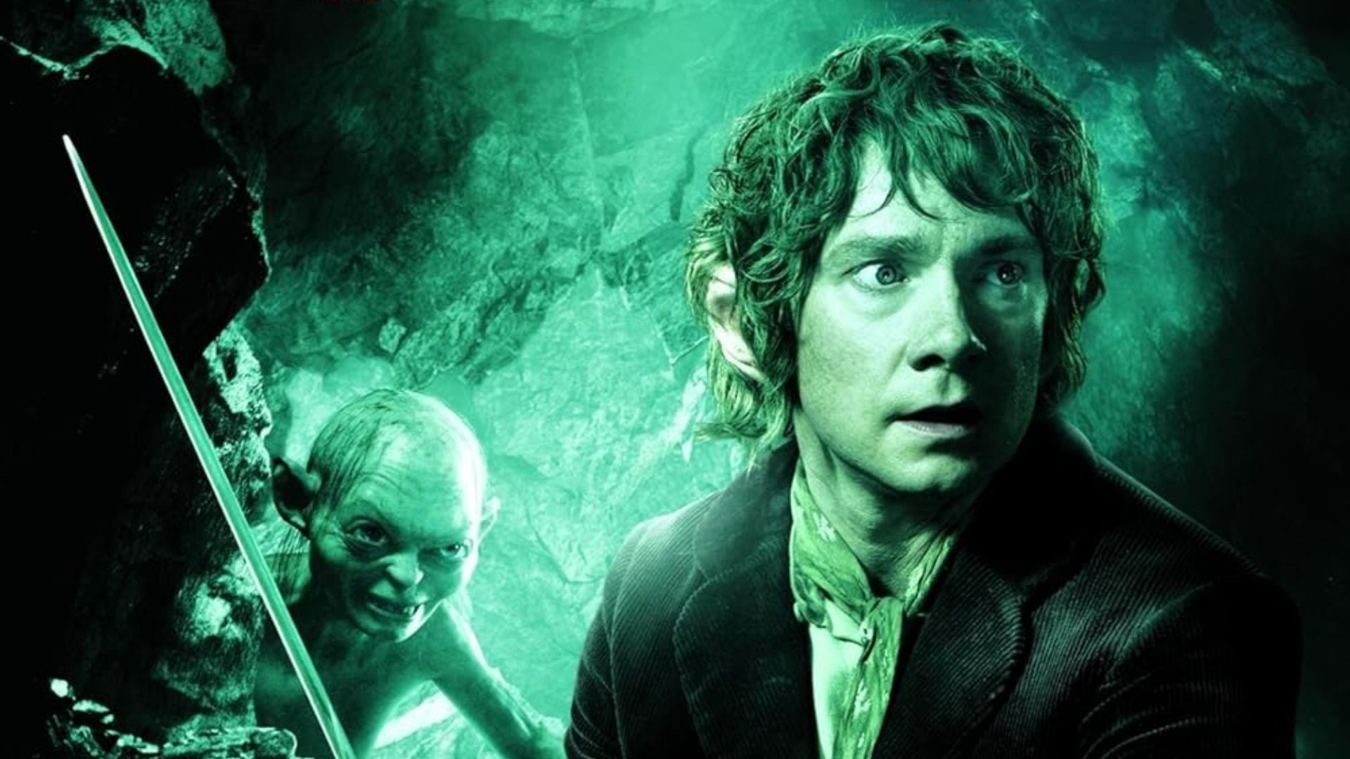 Actor Martin Freeman stands in a cave with a sword in his hands next to a gray creature with large eyes
