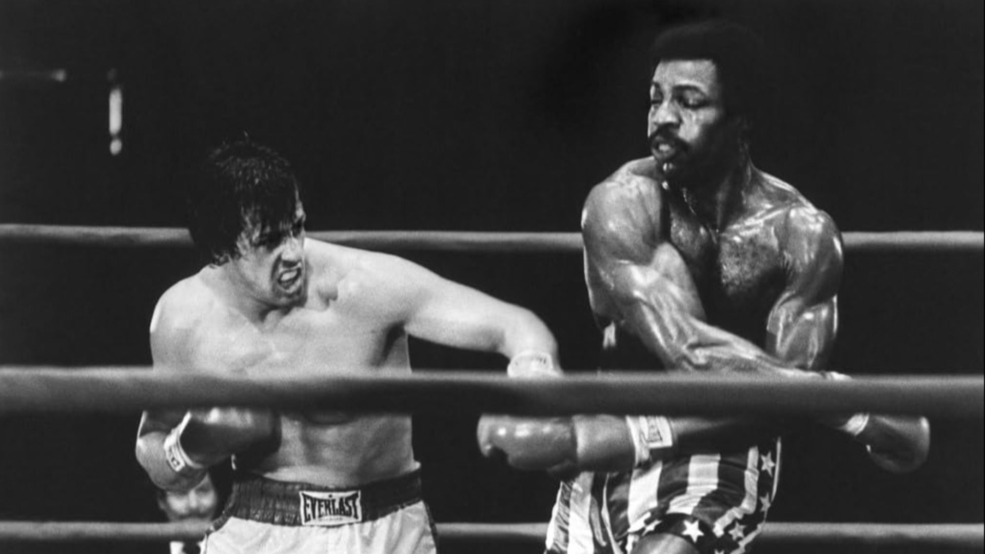 Actor Carl Weathers fights in a boxing ring with actor Sylvester Stallone