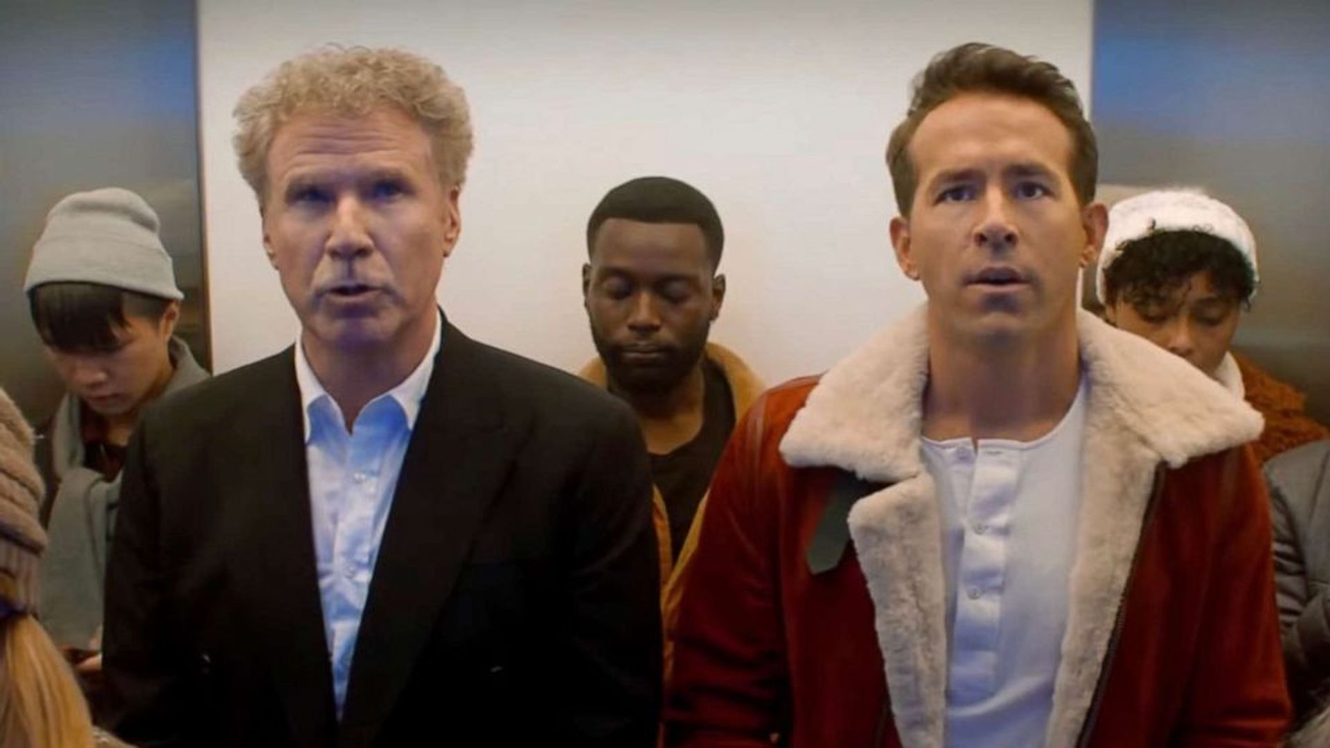 Ryan Reynolds and Will Ferrell riding in an elevator and staring at the same spot