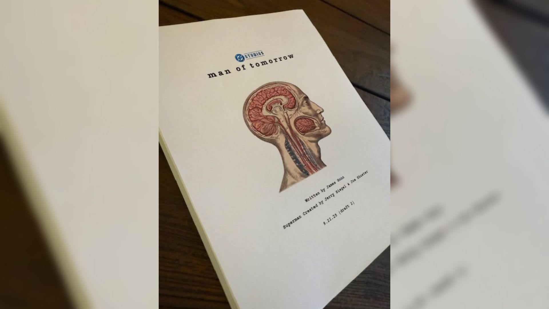 A stack of papers with an anatomical cross-section of a head drawn on the title page