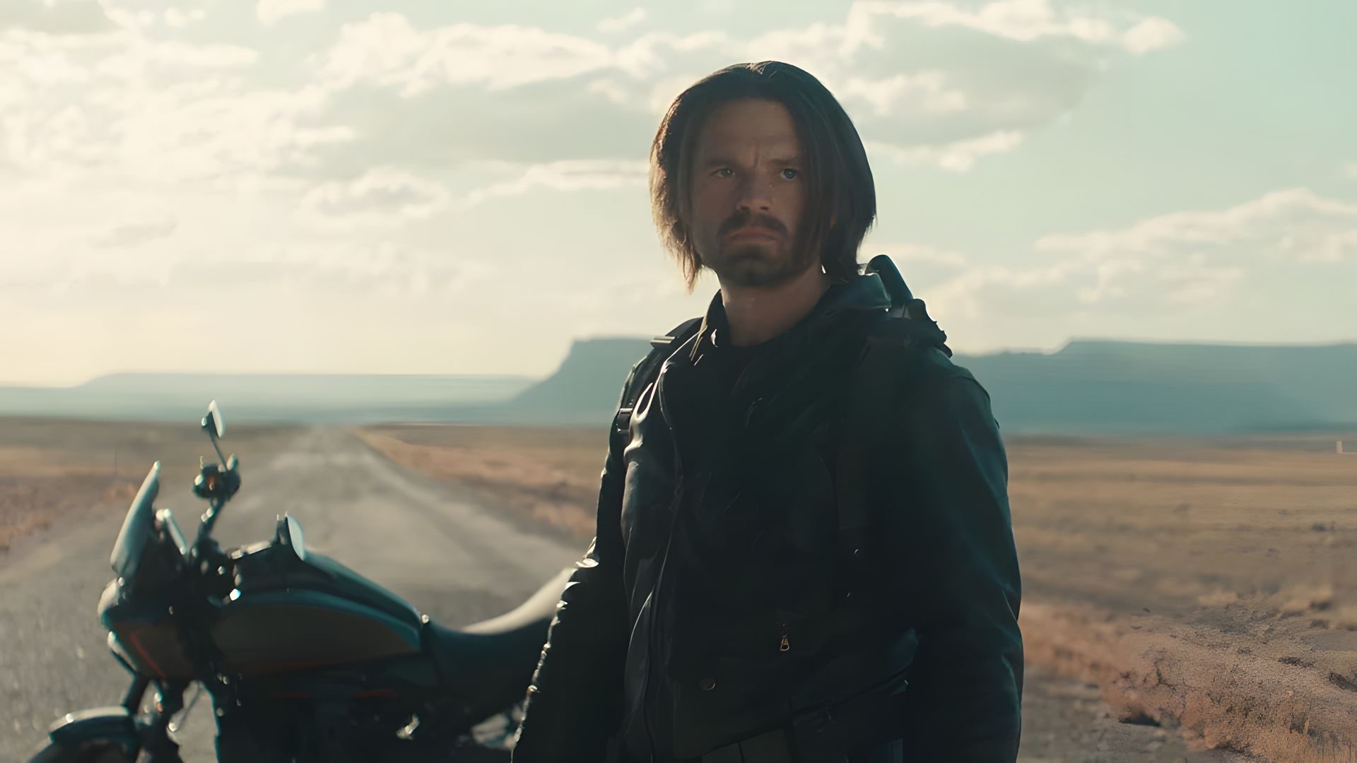 Sebastian Stan as the Winter Soldier against a backdrop of a motorcycle and road