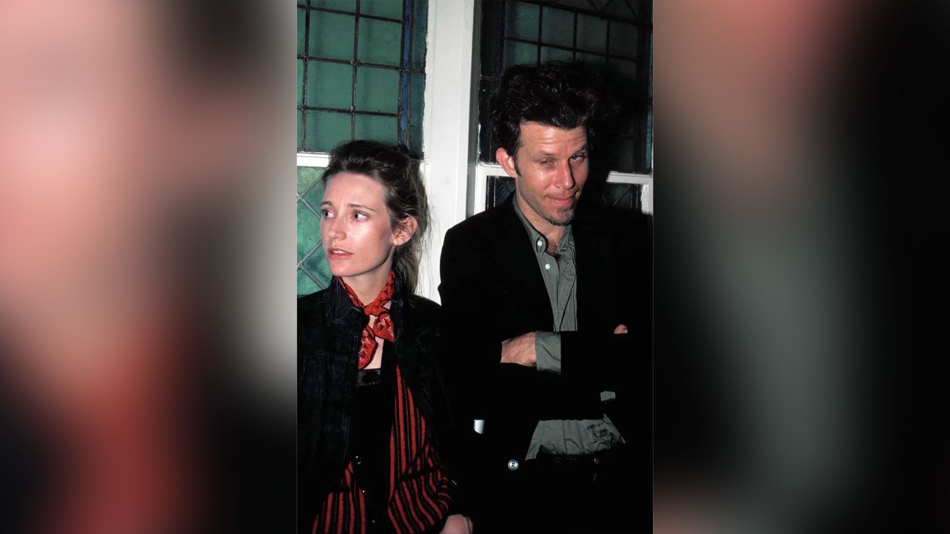 Tom Waits and Kathleen Brennan in their youth standing by a window