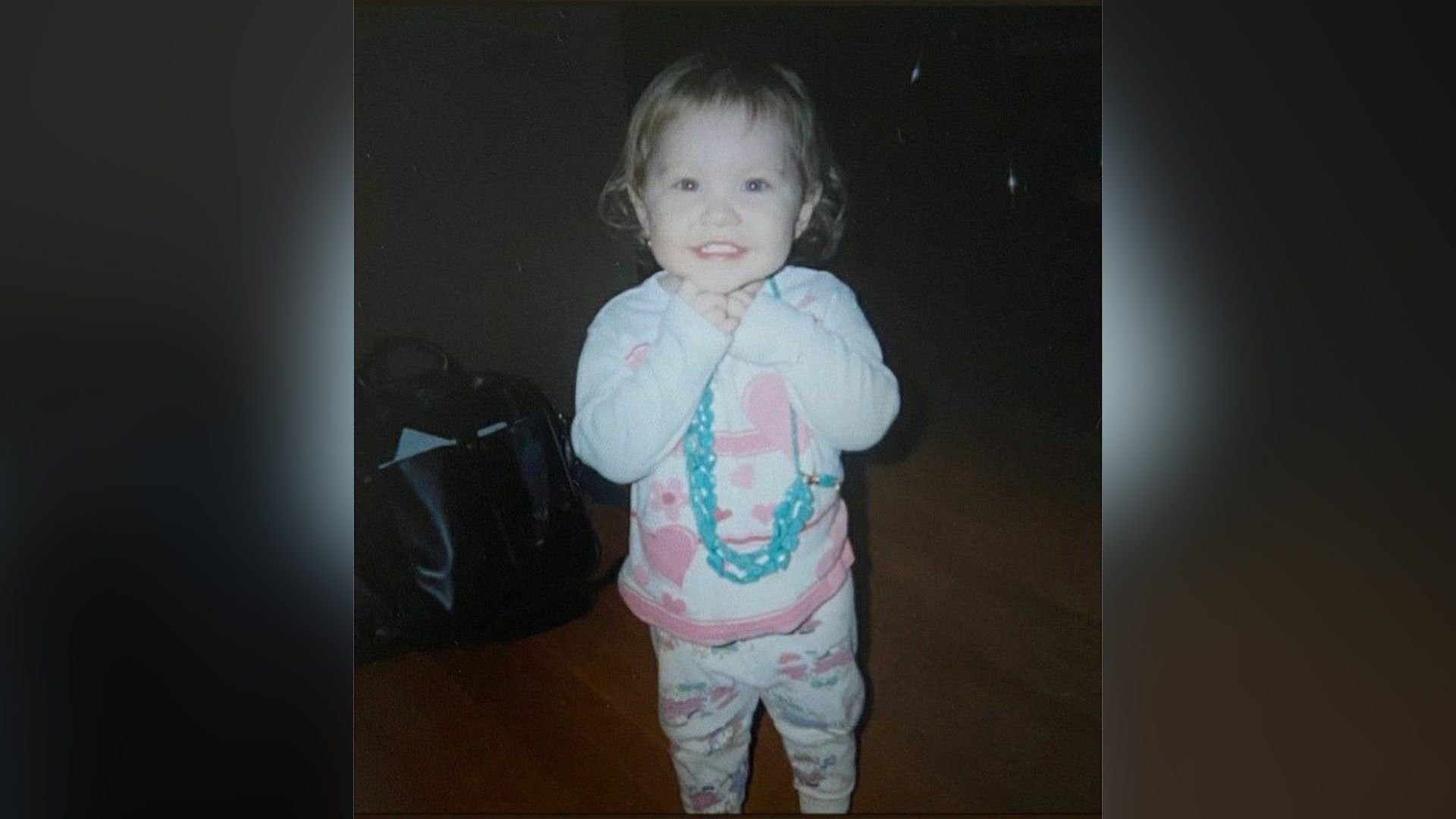 Ella Anderson as a child in white and pink pajamas