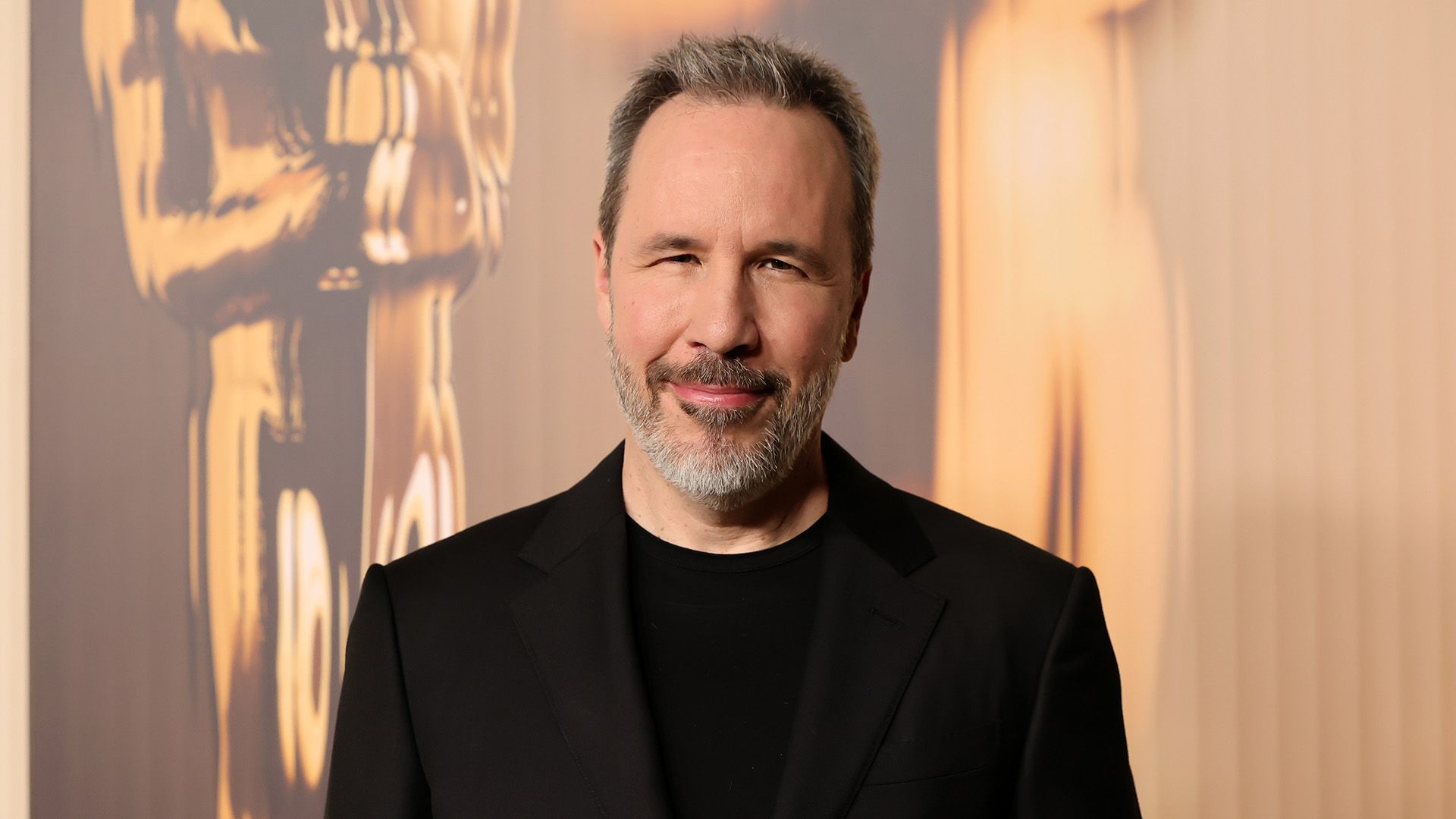 Director Denis Villeneuve in a black t-shirt and black blazer