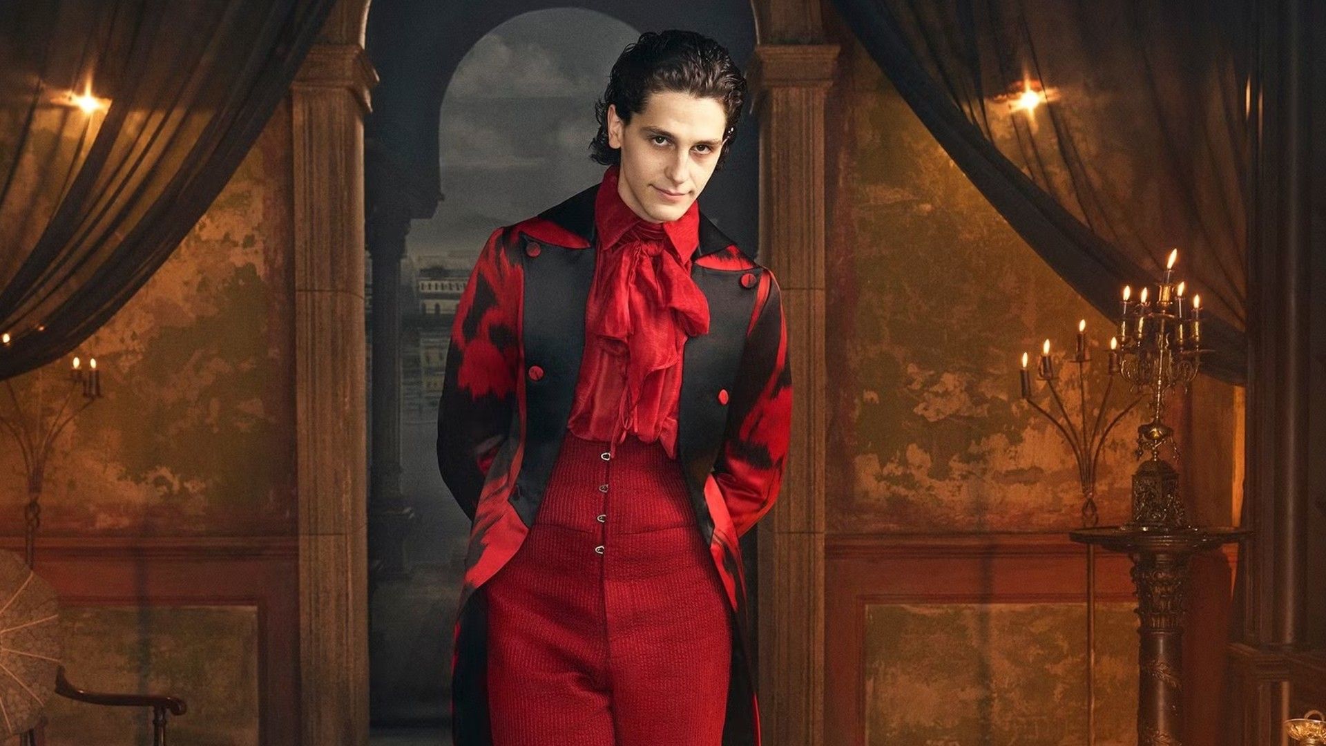 Owen Painter in full length wearing a red gothic costume