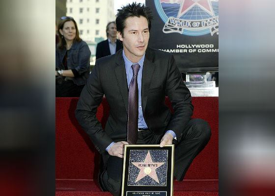 Keanu Reeves with his star on the Hollywood Walk of Fame